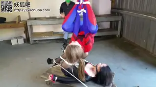 Spidergirl Caught and Unmasked Spidergirl tracks the evil villainess to her hideout at an abandoned trainyard.. As shes sneaking in to apprehend the slippery fiend, she gets ambushed from behind and tied up in a suspension. Finally, we find out Spidergirls true identity... Before the evil villainess can gloat too much, she too is grabbed and tied by a masked man. He leaves her tied under Spidergirls dangling body.. What will happen? Who will get untied first and rule the day? Watch the video to find out!!