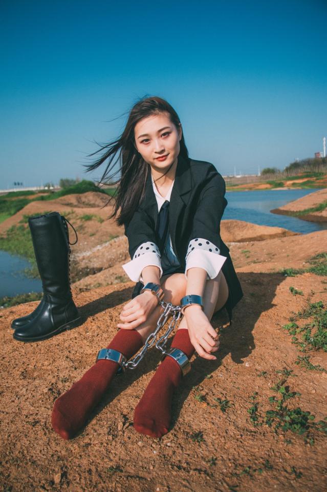 Day in steels - Beautiful Chinese gril in stainless steel shackles.  https://www.boundhub.com/albums/40018/handcuff-girl/