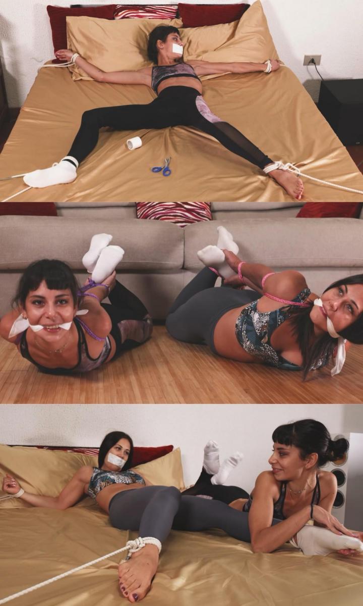 Mia and Mayla - Desire for two 米娅和梅拉穿着瑜伽裤、运动胸罩和薄踝袜。 当梅拉建议米娅她有更好的计划而不是看着她进行例行训练时。 莎一直想知道看到她的模特躺在床上会有什么感觉。 这正是即将发生的事情，我们看到她玩弄米娅的腿，感受她的整个身体，甚至在她用米娅出汗的袜子堵嘴后亲吻她被堵住的嘴唇。 第二天，女孩们的位置互换了，这一次是谁把梅拉·展鹰放在床上，让她尝到了自己的药。 甚至脱掉袜子，把袜子塞进另一个女人的嘴里，然后用胶带封住她的嘴，然后摸索、玩弄她的身体。 给她全身挠痒痒，然后让她无助地躺在床上过夜。 在最后一个场景中，我们发现米娅和梅拉并排绑在地板上，如果不是因为这样绑起来更灵活，他们最后为什么会做瑜伽呢？<br><br> <br><br>视频时长约为 10-15 分钟，其中每个模特大约有一半的视频时间是捆绑和堵嘴的，而另一个模特则与她一起玩Mia and Mayla are dressed in yoga pants, sports bras, and thin ankle socks.  When Mayla suggest Mia that she has better plan than watching her doing her training routine. Sha has always wondered how it would feel seeing her model bound spreadeagle on a bed. And this is exactly what is going to happen as we see her playing with Mia legs, feels her entire body, and even kisses her gagged lips after she has used Mia sweaty socks to gag her mouth. The day after the girls positions are reversed and this time is who got Mayla spreadeagle on bed making her tastes her own medicine. Even takes off her socks and stuffs her socks in the other woman's mouth before taping her mouth and then feeling and playing with her body. Tickling her all over before leaving her helpless on the bed for the evening. In the last scene we find Mia and Mayla hogtied side by side on the floor, in the end wy would they make yoga if not for being more flexible when they are all trussed up like this?<br><br> <br><br>The video would be about 10-15 minutes long with each model spending about half the video bound and gagged while the other model plays with her